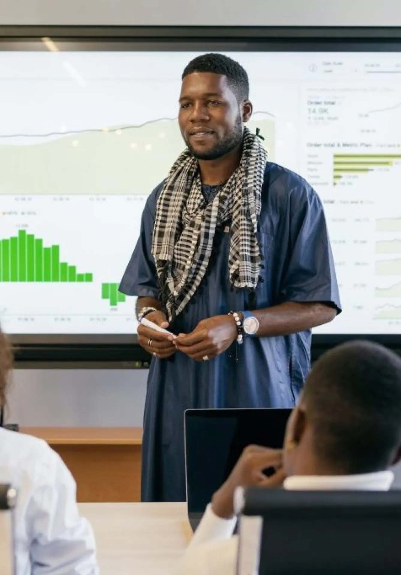A speaker presenting to an audience in a training room.